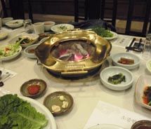 Samwon Garden restaurant side dishes surround the main course, a traditional Korean barbecue using red-hot coals. // © 2011 Pride Travel/S. Nathan DePetris Samwon Garden restaurant side dishes surround the main course, a traditional Korean barbecue using red-hot coals. // © 2011 Pride Travel/S. Nathan DePetris